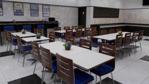 a dining room with tables and chairs with flowers on them at Toyoko Inn Osaka Namba Nippombashi in Osaka