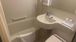 a small bathroom with a sink and a toilet at Toyoko Inn Osaka Namba Nippombashi in Osaka