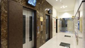 a lobby of a building with a glass door at Toyoko Inn Osaka Namba Nippombashi in Osaka