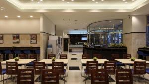 a restaurant with tables and chairs in a room at Toyoko Inn Osaka Namba Nippombashi in Osaka