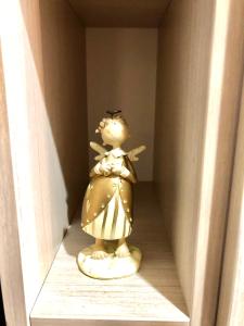 a small doll sitting on a shelf in a room at Devintoji Banga in Palanga