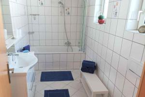 a bathroom with a sink and a toilet and a tub at 3 room Apartment in Bürstadt +2 photos