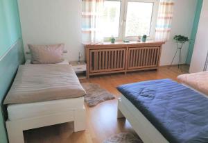 a bedroom with two beds and a window at 3 room Apartment in Bürstadt