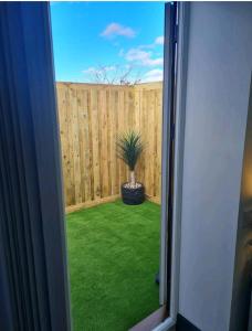 a window view of a backyard with a fence and a potted plant at Charming 1-Bed Apartment in Peebles in Peebles