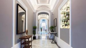 a hallway with white walls and a white ceiling at AX The Saint John in Valletta