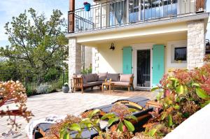 a patio with a couch and chairs on a house at Villa Gisella in Nedeščina +35 photos