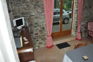 a room with a table and a window with a car at La Ferme de Montaigu in Montaigu-les-Bois
