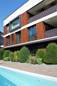 a building with a swimming pool in front of it at ANTON Dolomites Hideaway in Brunico