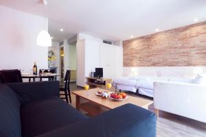 
a living room filled with furniture and a tv at Inside Barcelona Apartments Sants in Barcelona
