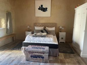 a bedroom with a bed and two night stands at Le Petit courault in Pamproux