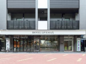 a store front of a building with tables and chairs at HOTEL LiVEMAX Nagoya Sakae East in Nagoya