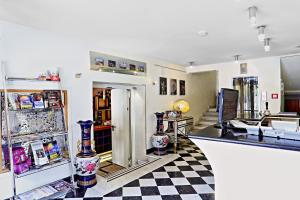 a room with a checkered floor and a refrigerator at Hotel San Valentino in Rome