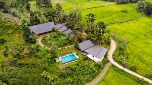 an aerial view of a house with a swimming pool at Cinnamon Village Sinharaja in Deniyaya