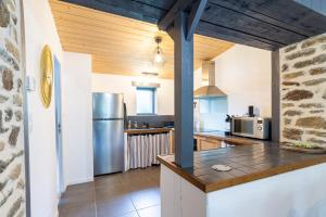 una cucina con pareti bianche e soffitti in legno di Bel Even a Plouër-sur-Rance