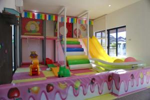 a childs play room with a slide and a playground at KK Garden 小院 in Hua Hin