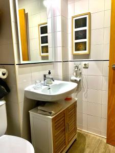 a bathroom with a sink and a toilet at MÍ casa YOUR HOME in Valencia +30 photos