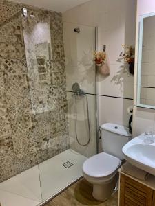 a bathroom with a shower and a toilet and a sink at MÍ casa YOUR HOME in Valencia