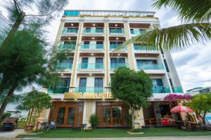 a large white building with a sign on it at HOẰNG MINH HOTEL in Sầm Sơn