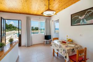 a dining room with a table and a view of the ocean at "OceanBreeze'' Studio in Gaios