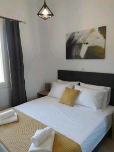 1 dormitorio con cama blanca y ventana en Πλατανακι 1 Family Friendly, en Ándros