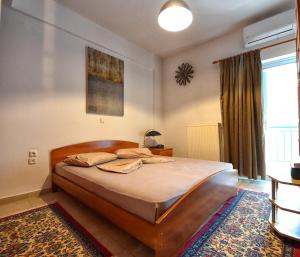 a bedroom with a bed and a large window at Maisonette Ilios in Plisioí