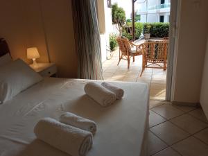 a bedroom with a bed with towels on it at Sea Side House Kourouta in Kourouta