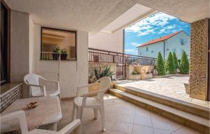 a balcony with a table and chairs and a patio at Cozy Apartment In Jadranovo in Jadranovo