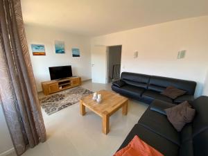 a living room with a couch and a coffee table at Entspann you in Wangerland