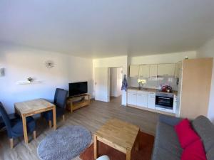 a living room with a couch and a table at Entspann you in Wangerland