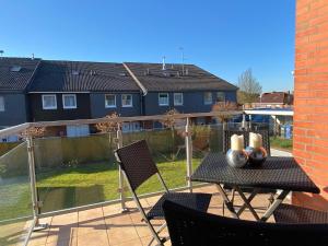 a patio with a table and chairs on a balcony at Entspann you in Wangerland