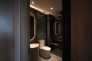 a bathroom with a toilet and a sink and a shower at SHI HOUSE by Haviland in Danang