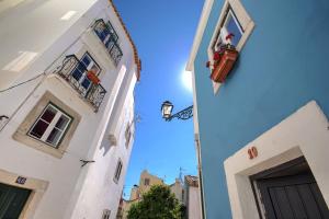 a view of a street between two buildings at The Famous Blue House in Lisbon
