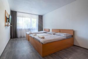 Postel nebo postele na pokoji v ubytování Apartmány a Studia Zámecký park