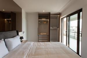 a bedroom with a bed and a sliding glass door at Prime penthouse in Athens