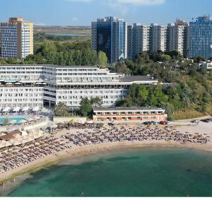 an aerial view of a beach with umbrellas and buildings at Olimp Family - Olimp Sea View Apartments in Olimp