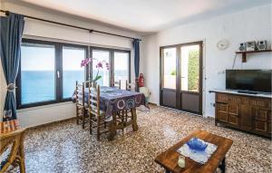 a living room with a table and a view of the ocean at Costa Nova in Jávea