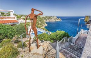 a metal sculpture on the side of a staircase with the ocean at Costa Nova in Jávea