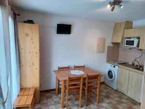 a kitchen with a table and chairs and a microwave at Appartement Le Biot, 2 pièces, 6 personnes - FR-1-573-56 in Le Biot