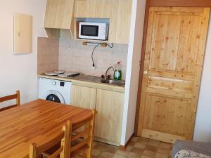 a small kitchen with a table and a microwave at Appartement Le Biot, 2 pièces, 6 personnes - FR-1-573-56 in Le Biot