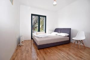 a bedroom with a bed and a table and a window at Jednosoban stan Milinic in Herceg-Novi