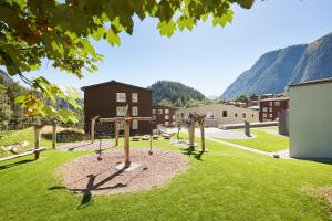 a park with a playground in the middle of a field at Reka-Feriendorf Blatten-Belalp in Blatten bei Naters