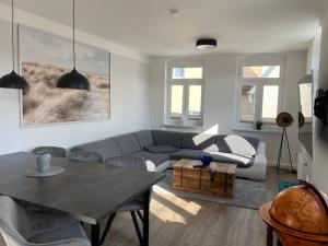 a living room with a couch and a table at Cityapartments am Hafen in Waren