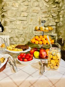 a table topped with plates of fruit and other foods at Agriturismo Montagna Verde Apella in Licciana Nardi