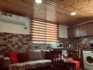 a living room with a couch in a kitchen at IBN Khaldoon in Madaba