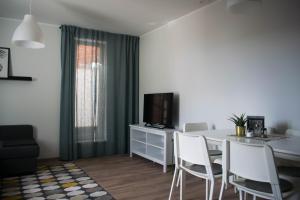 a living room with a dining table and a television at Just Rest Automatic Hostel in Viljandi