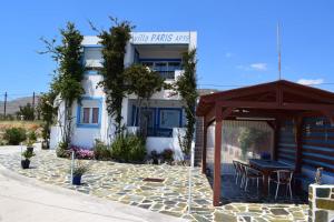 a building with a table and chairs in front of it at Villa Paris in Xerokampos