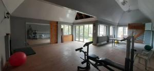 a living room with a gym with a treadmill at Динара in Cholpon-Ata