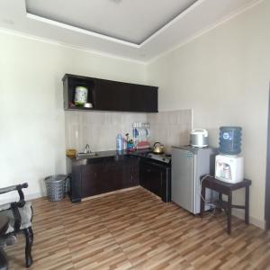 a kitchen with a sink and a refrigerator at Villa Names2 Gunung Bunder in Gunungpicung