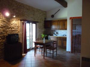 a kitchen with a table and chairs in a room at Mas des Esclots in Nîmes