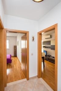 a hallway with a door leading to a living room at Apartment Buby in Dubrovnik